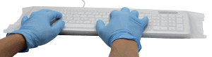 Gloved hands are typing on a keyboard wrapped in a Man & Machine Universal drape